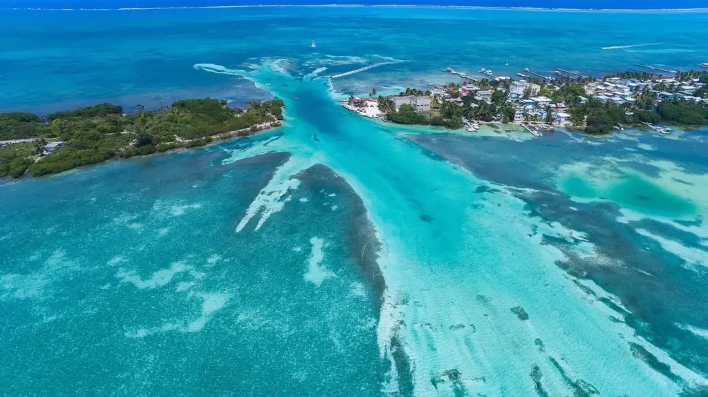 Aerial view of Caye Caulker, Belize, showing the narrow channel called the Split, turquoise shallows and the village