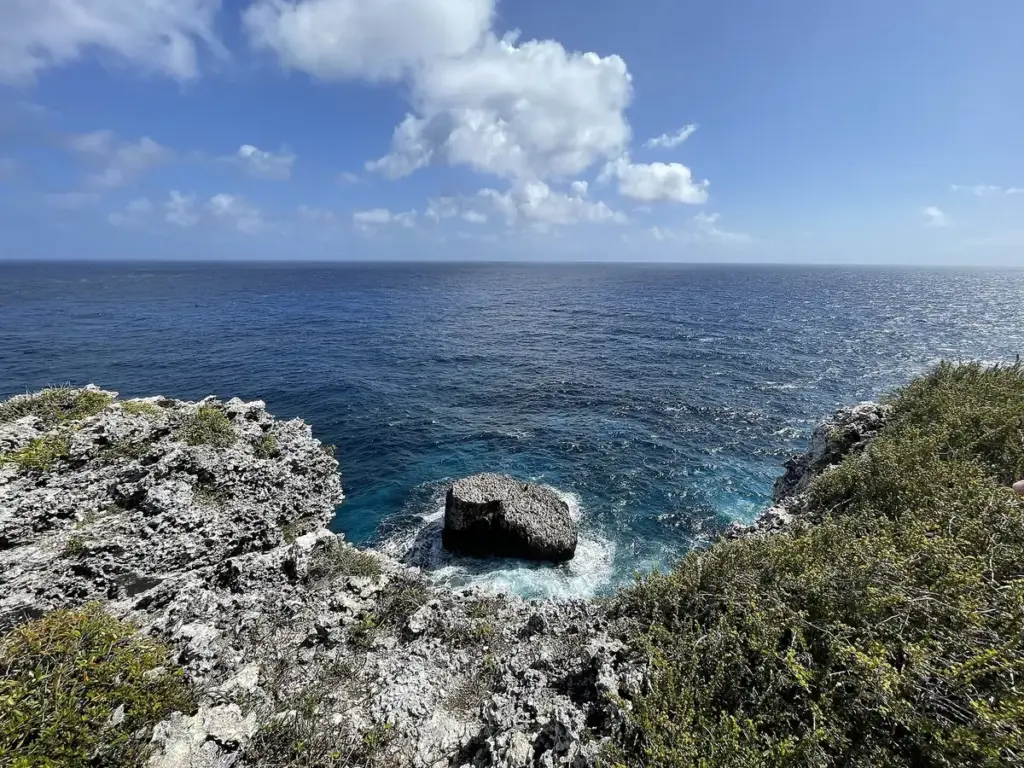Rocky limestone shoreline and deep blue sea seen from the top of the Bluff on Cayman Brac