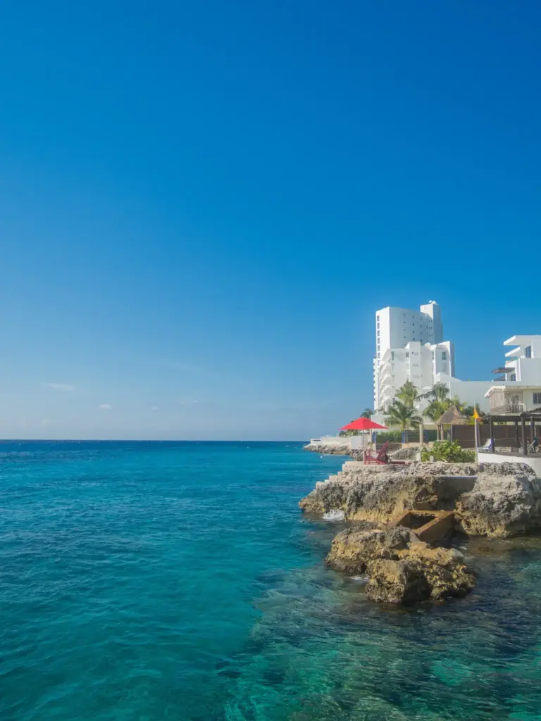 Hotel on the rocky west coast of Cozumel beside clear turquoise water