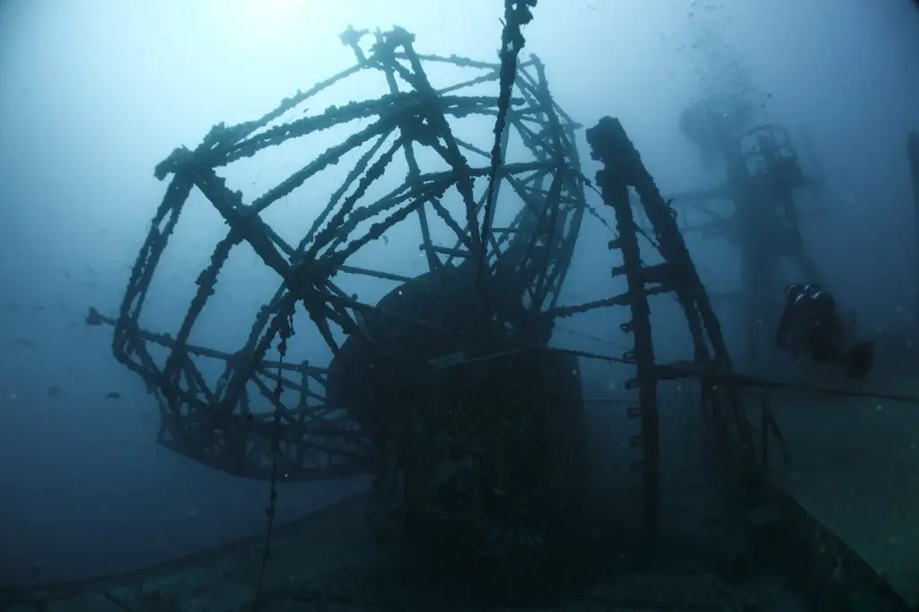 Diver silhouetted beside the radar antenna structure of the USNS General Hoyt S. Vandenberg wreck off Key West